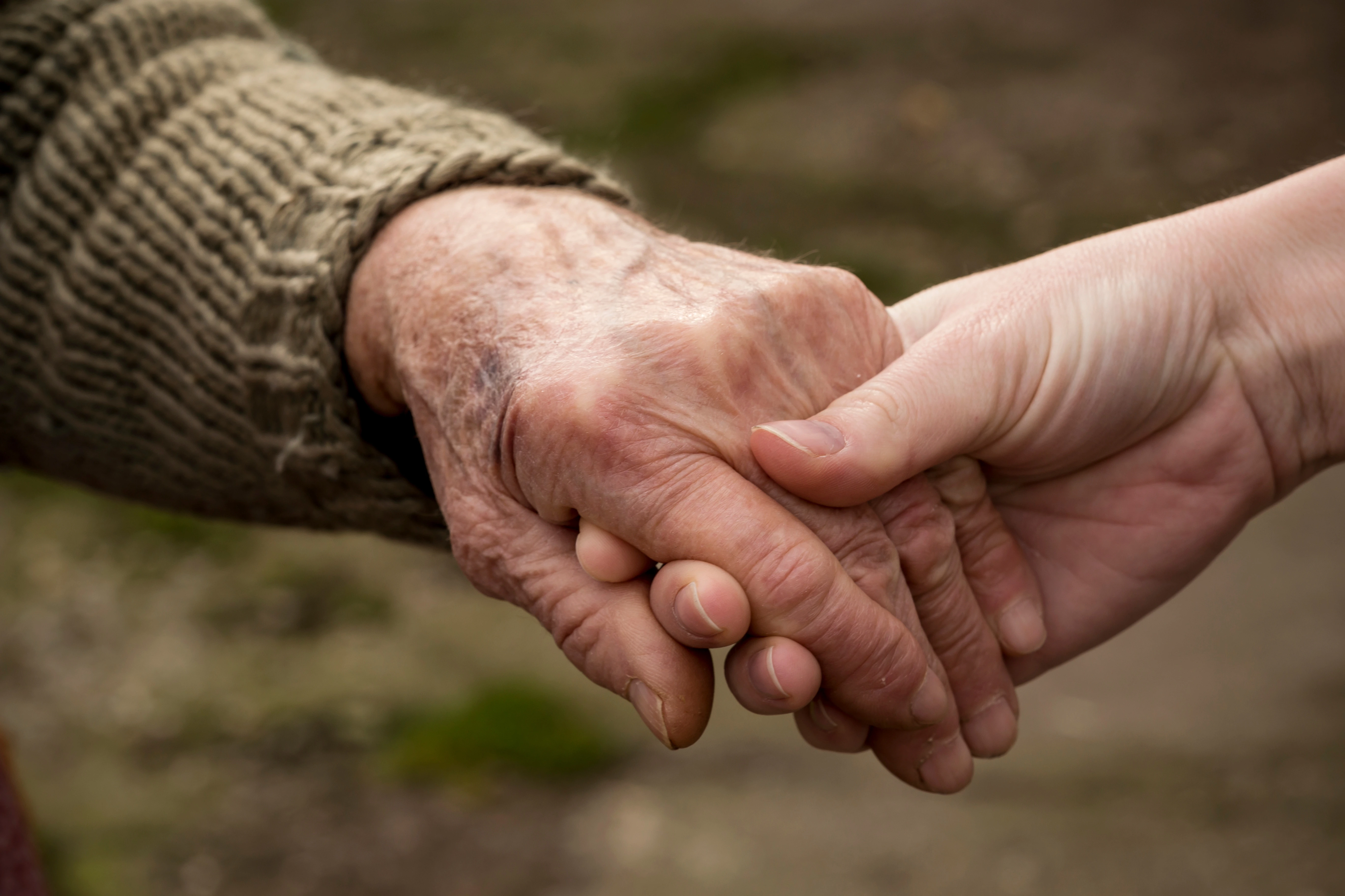 Hands held outdoors